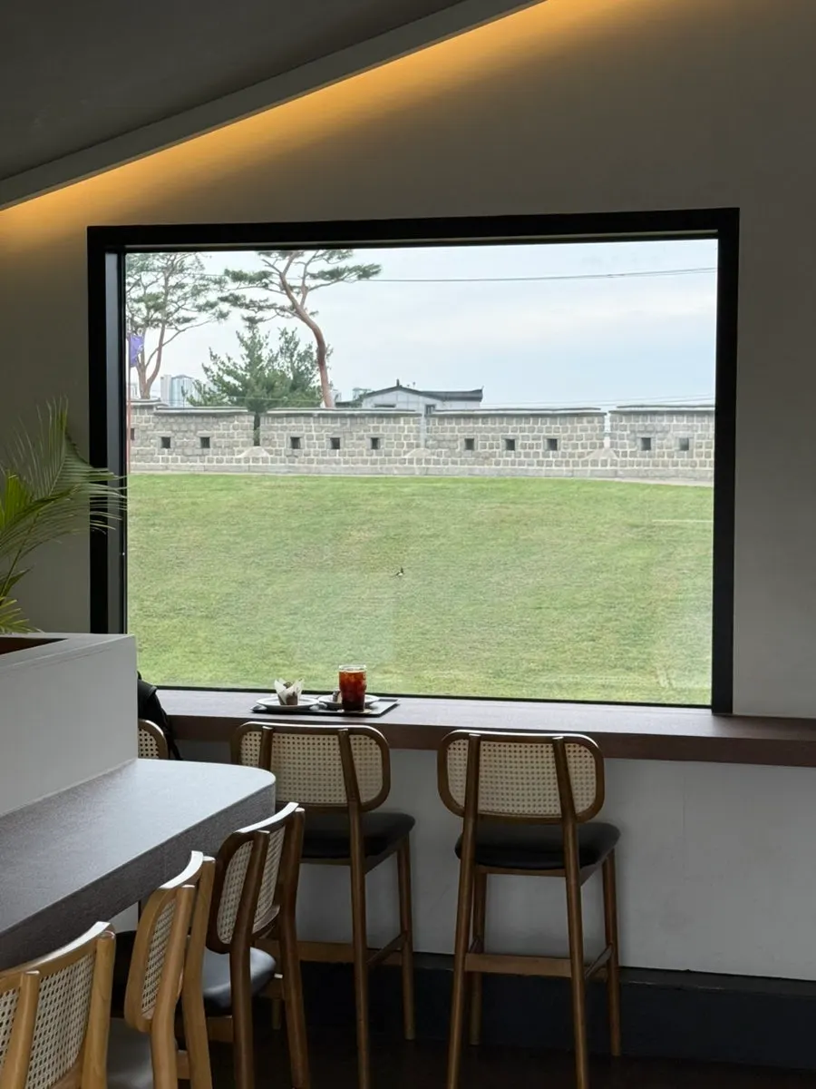 Hwaseong Fortress wall view through the wide 3rd-floor window