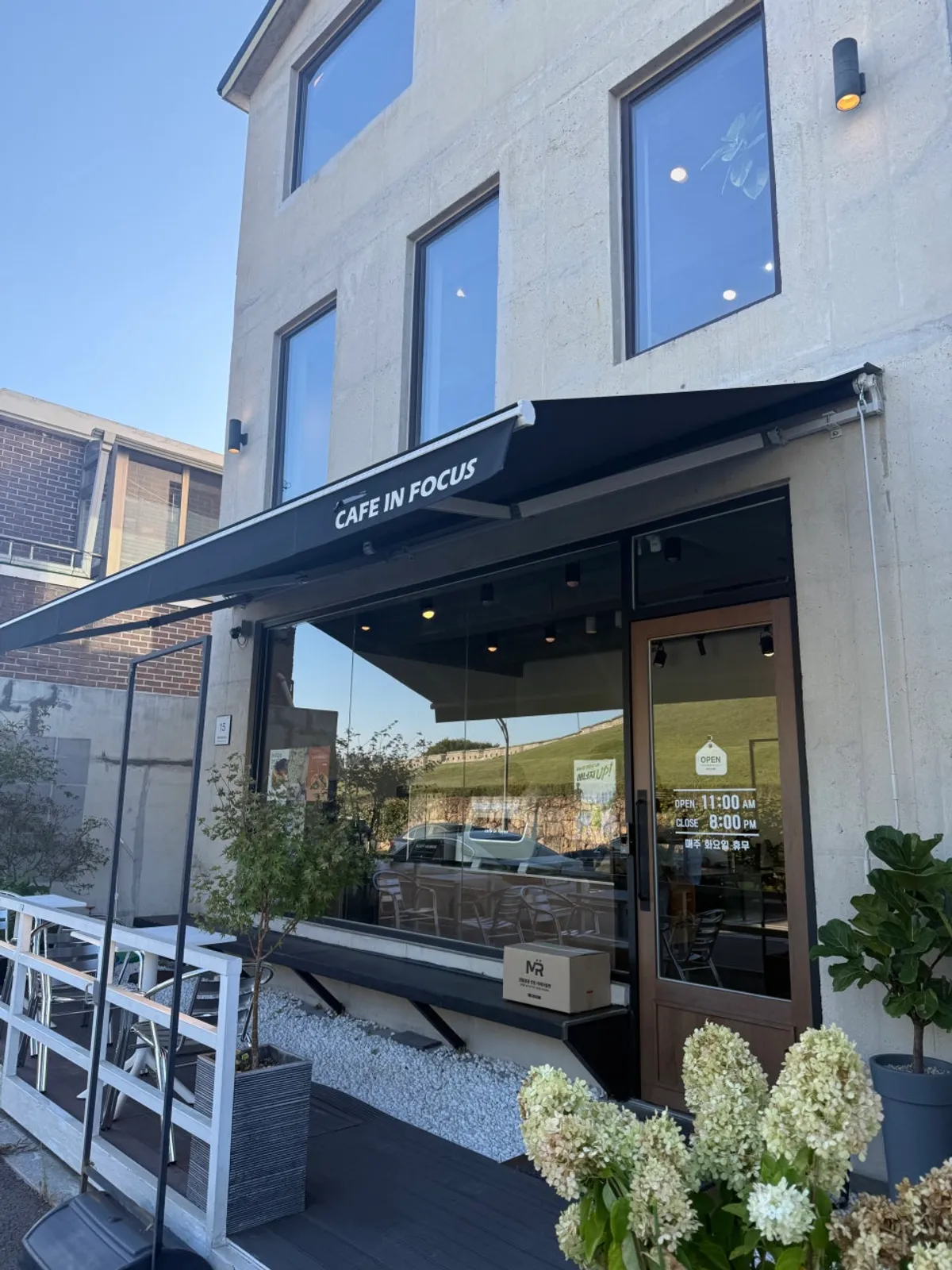 View of Caffeine Focus with the Hwaseong Fortress wall in the background
