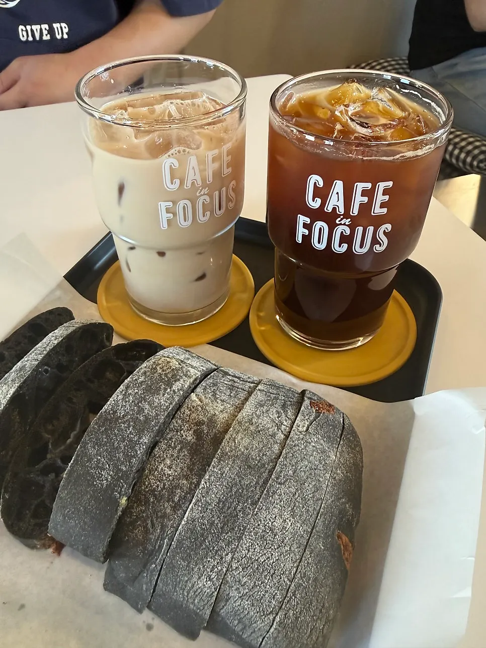 Squid ink cheese ciabatta served with two drinks
