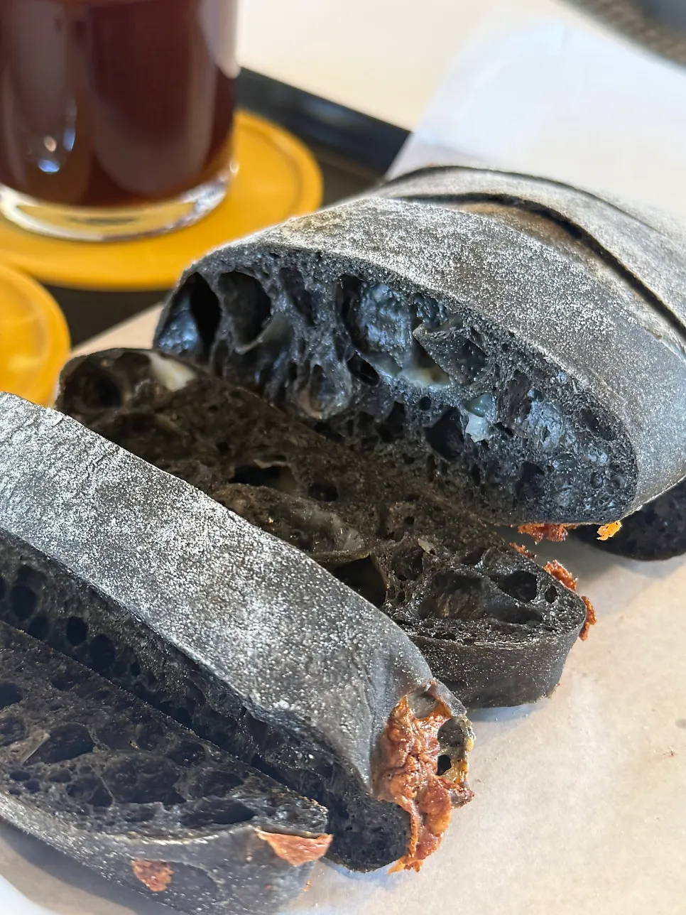Squid ink cheese ciabatta served on a plate