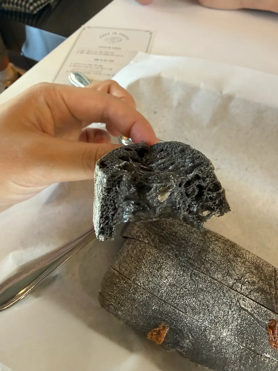 Cross-section of a bitten-into squid ink cheese ciabatta