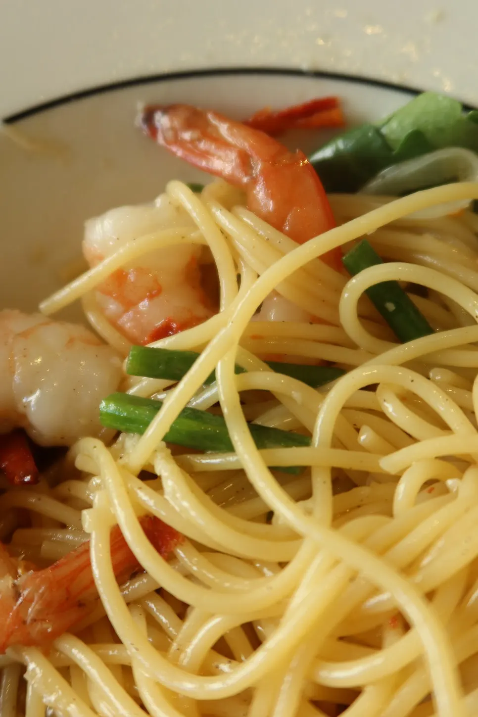 Garlic scape pasta topped with shrimp and arugula