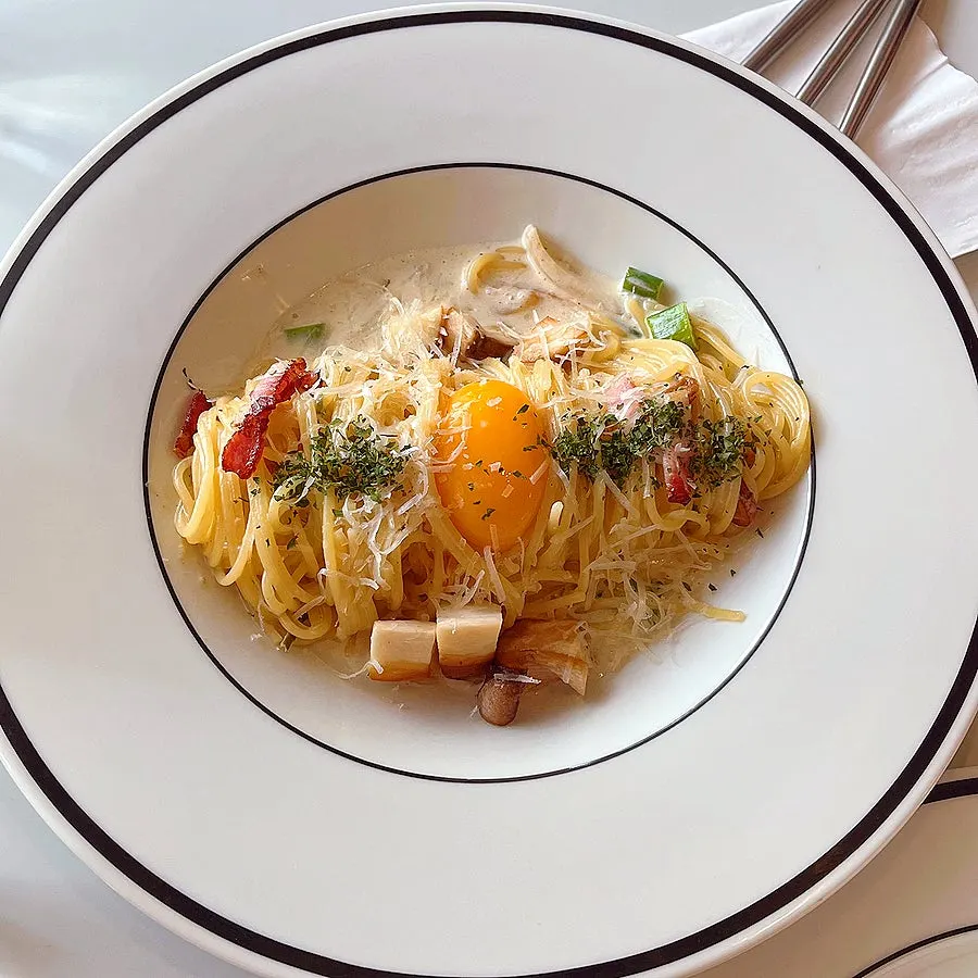 Green onion cream pasta topped with egg yolk
