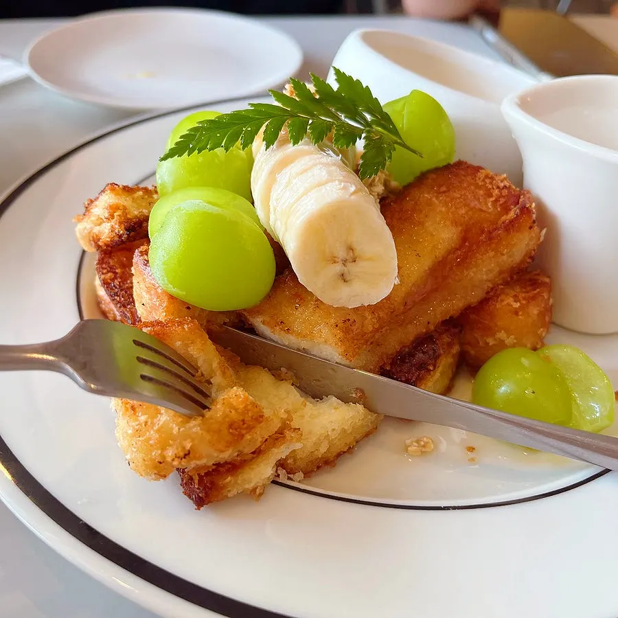 A piece of French toast drizzled with maple syrup