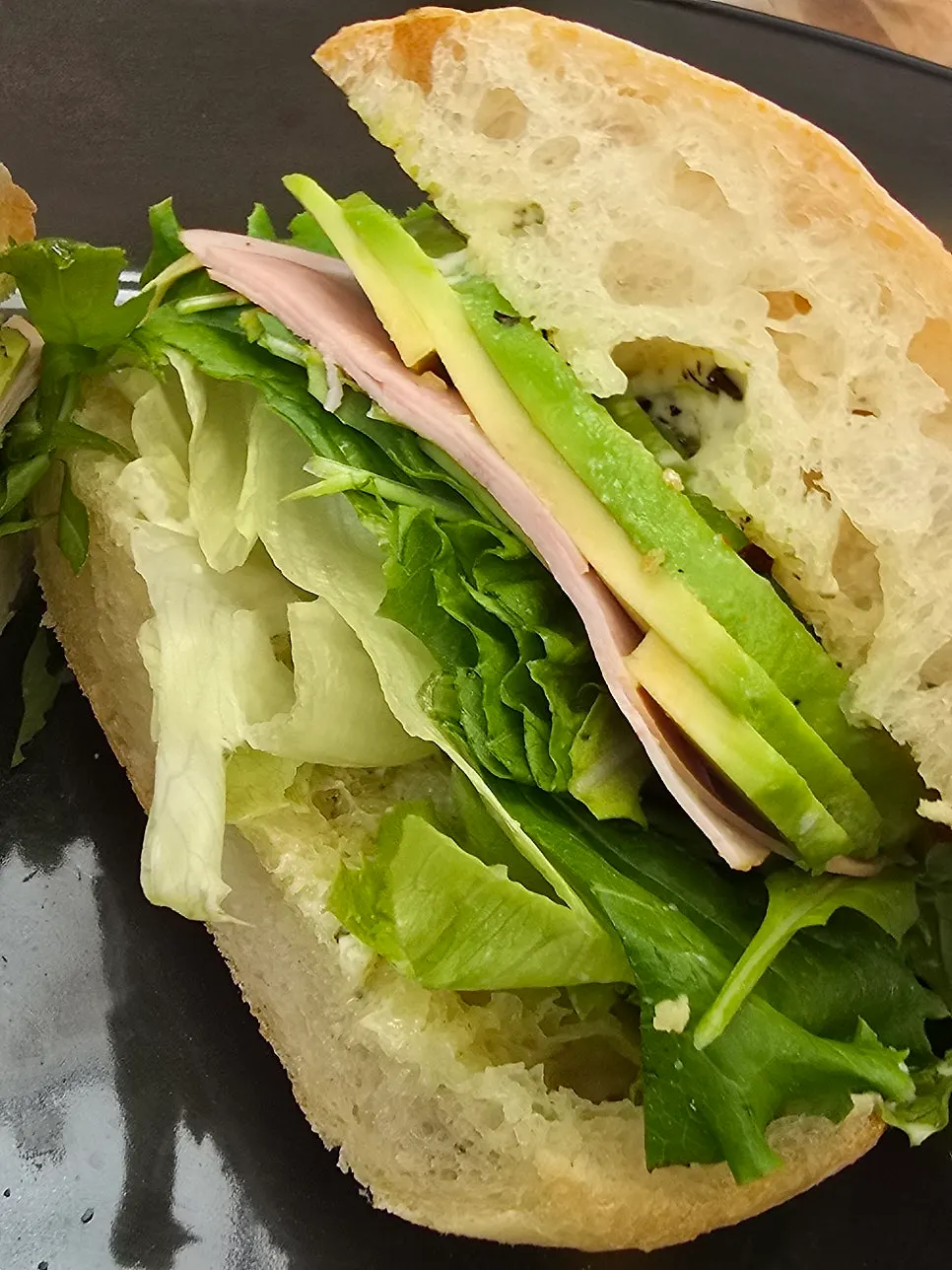 Cross-section of the ciabatta sandwich with avocado and vegetables