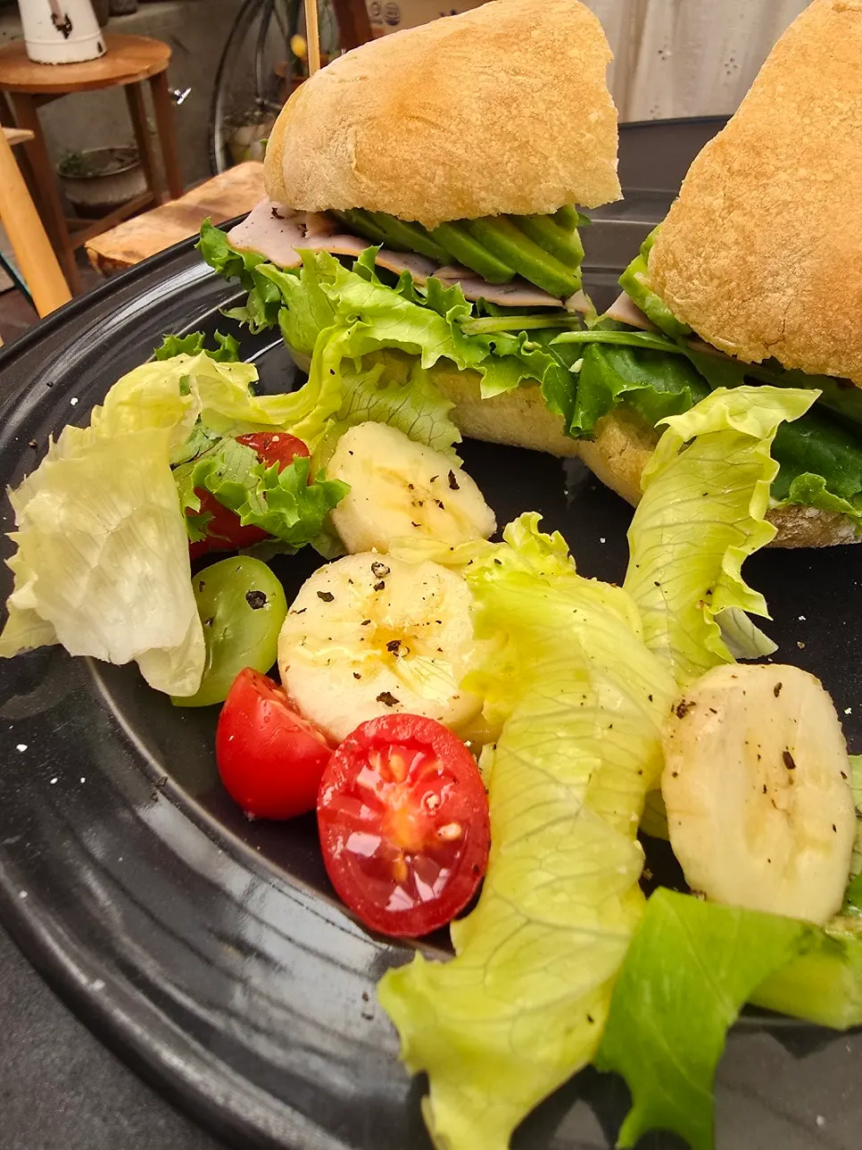 Salad with oriental dressing served alongside the sandwich