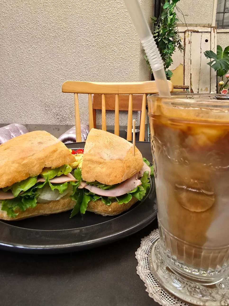 Brunch table set with ciabatta sandwich and vanilla bean latte