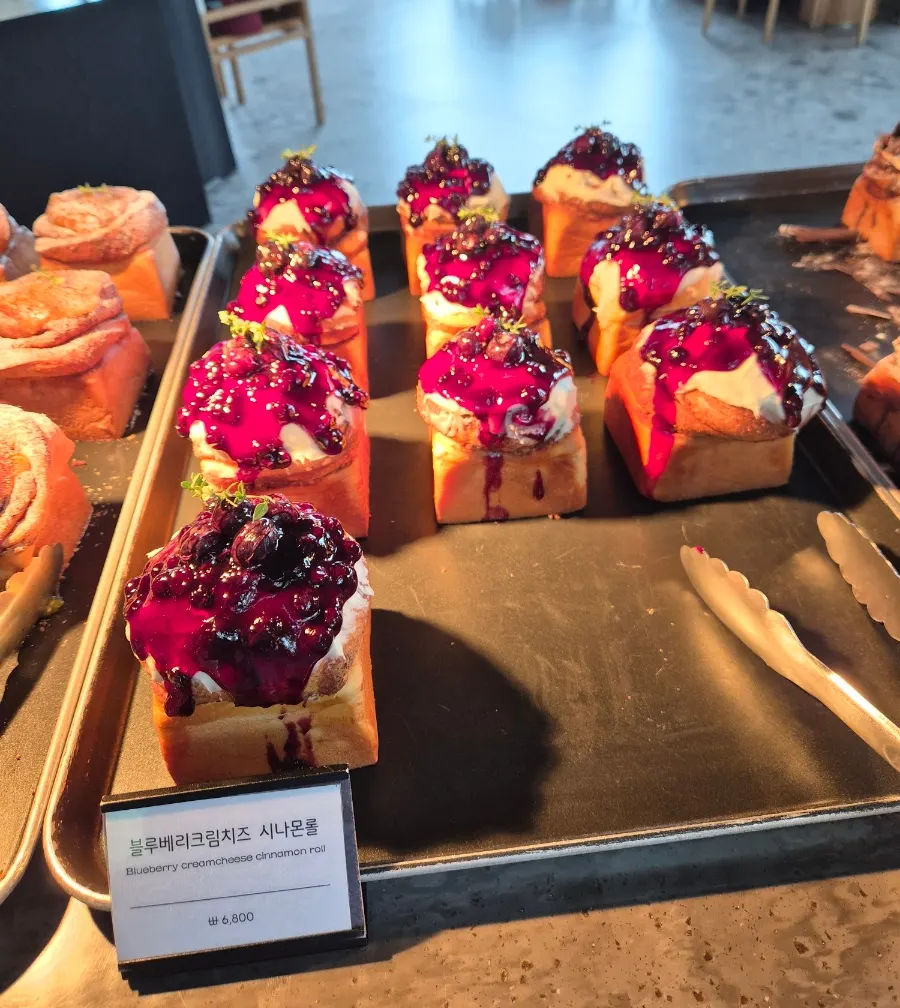 Blueberry cream cheese cinnamon rolls on display at MUG