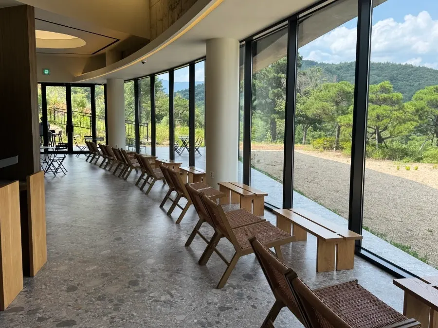 Rattan chairs by the window with a mountain view
