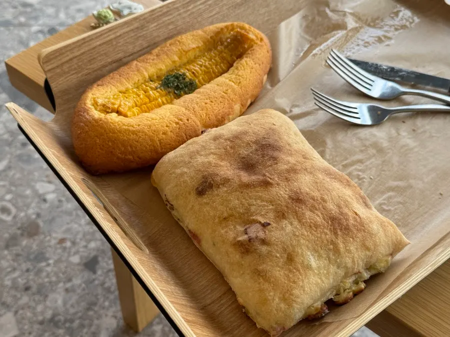 Table setting with blueberry cream cheese cinnamon roll and gorgonzola ciabatta