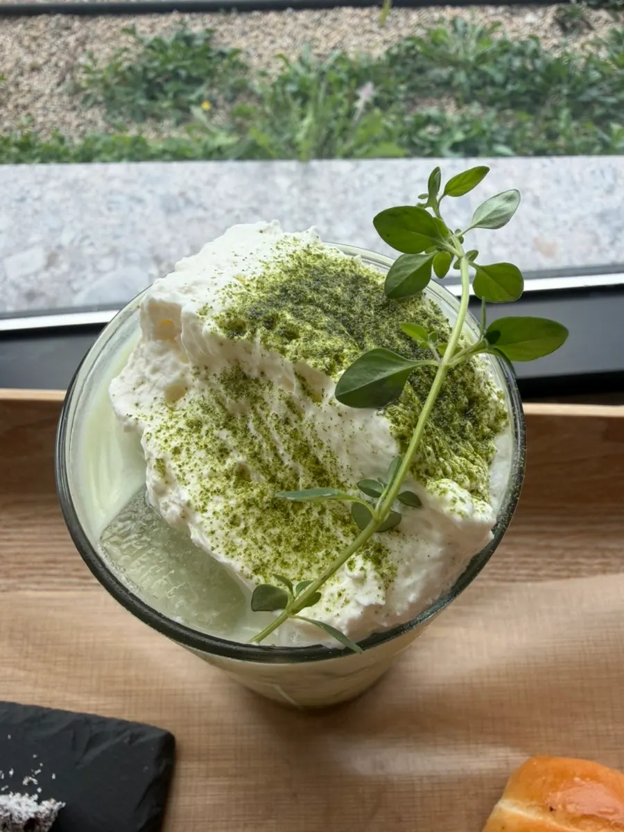 Ordered matcha latte and bread set on the table