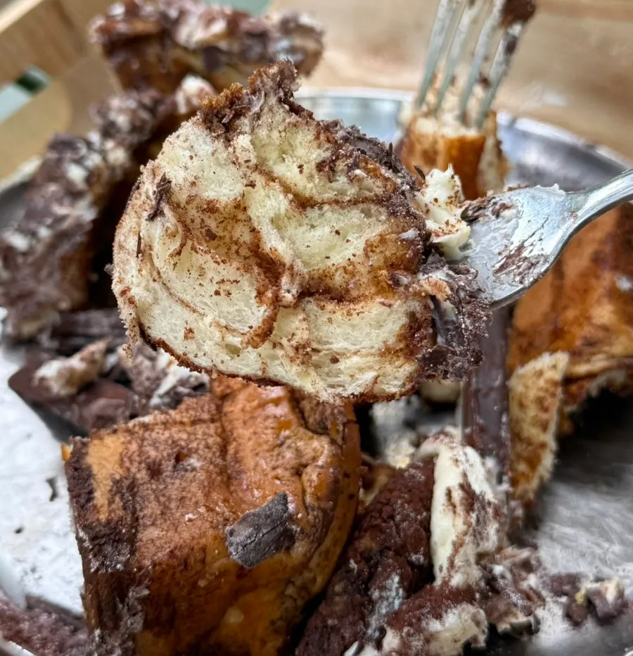 Close-up of the tiramisu cinnamon roll studded with chocolate