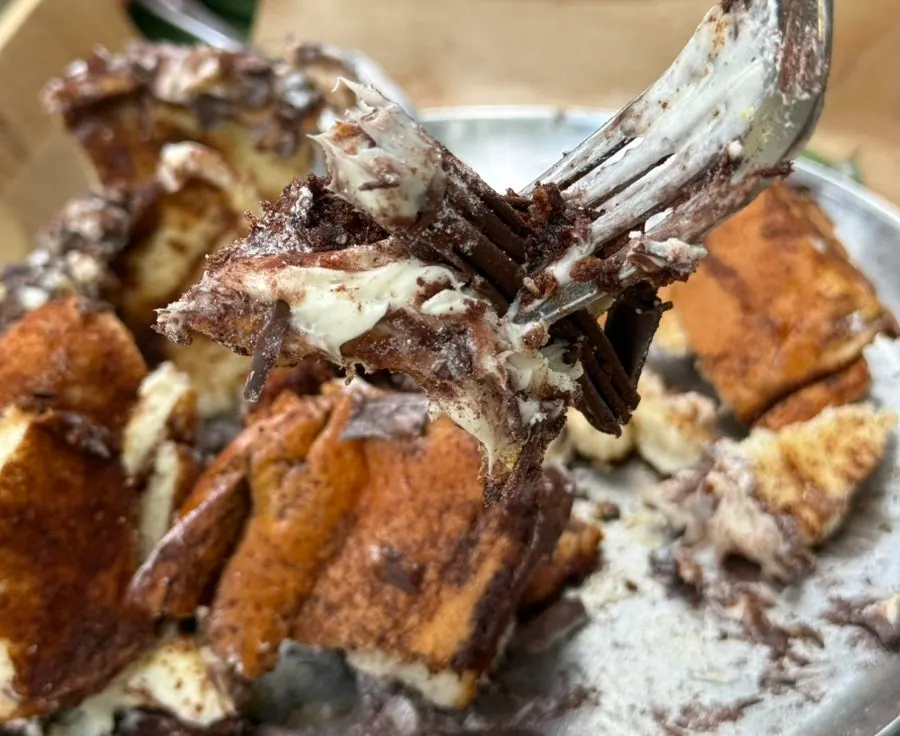 Tiramisu cinnamon roll and drink set on an outdoor table