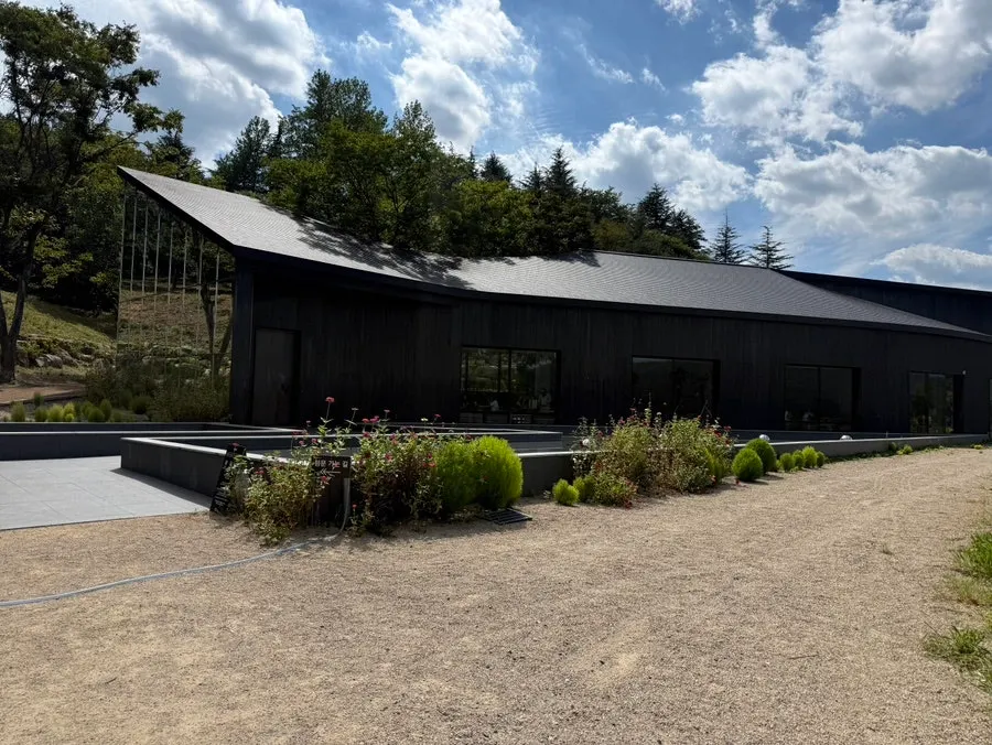 MUG's charred ink-black exterior building