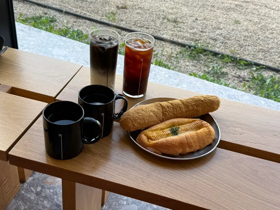 Americano, black latte, and bread spread at MUG