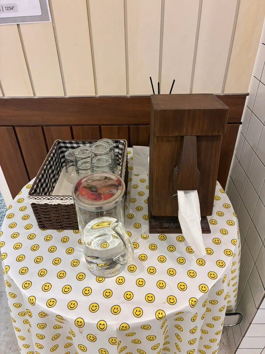Self-serve water and a Moai statue tissue holder