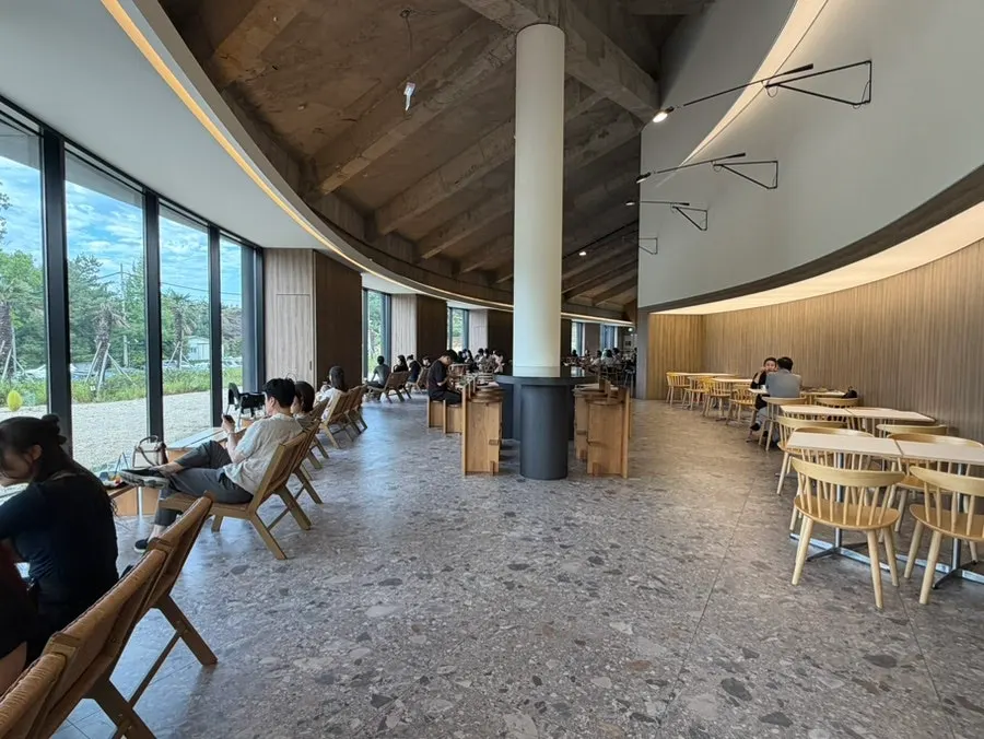 Seating spread out beside MUG's floor-to-ceiling windows