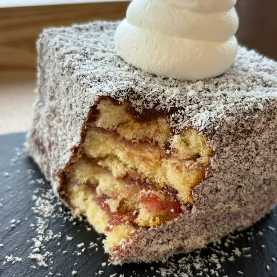 Cross-section of the Lamington cake with strawberry jam inside