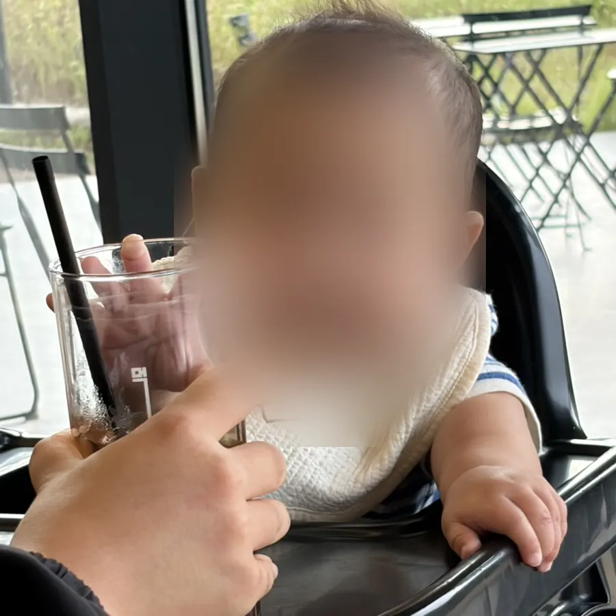 Baby sitting in a high chair at MUG