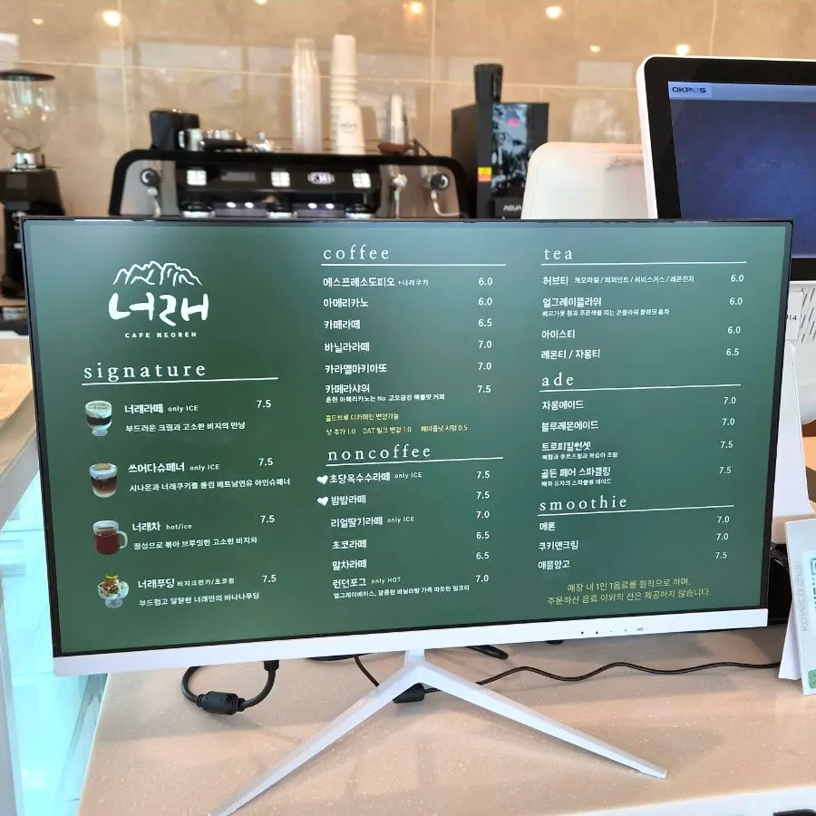 Large floor-to-ceiling windows and high ceilings at Cafe Neorae