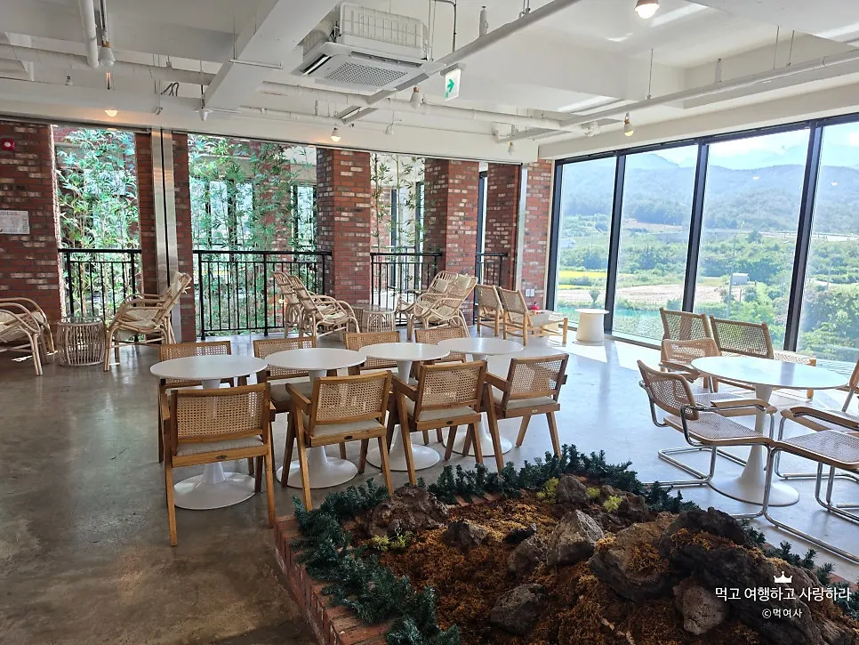 Spacious 3rd-floor seating near the windows at Cafe Neorae