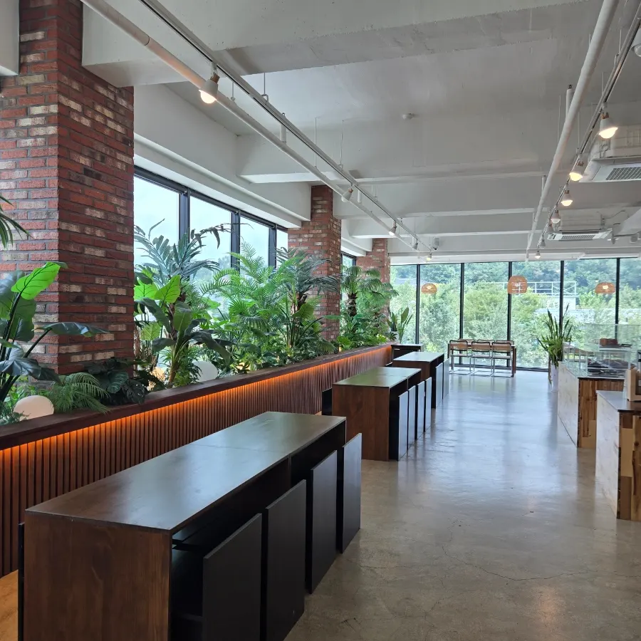 Interior of Cafe Neorae's 2nd-floor hall with floor-to-ceiling windows