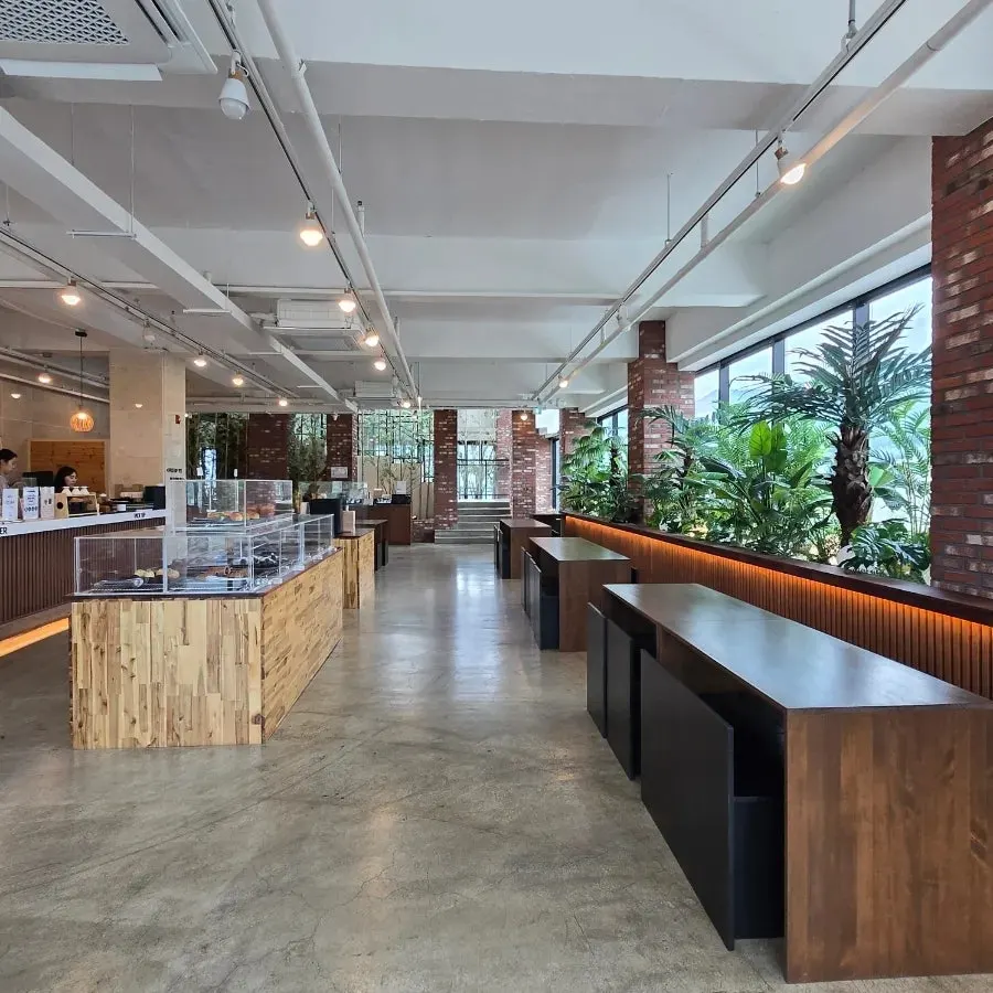 Wooden table beside Cafe Neorae's floor-to-ceiling window
