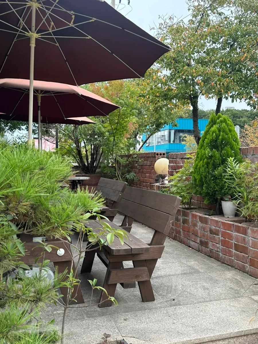 Terrace at Cafe Pomun with parasols and wooden benches