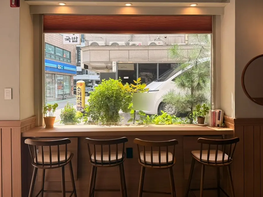 Window seat at Cafe Ssum with plants visible through the glass