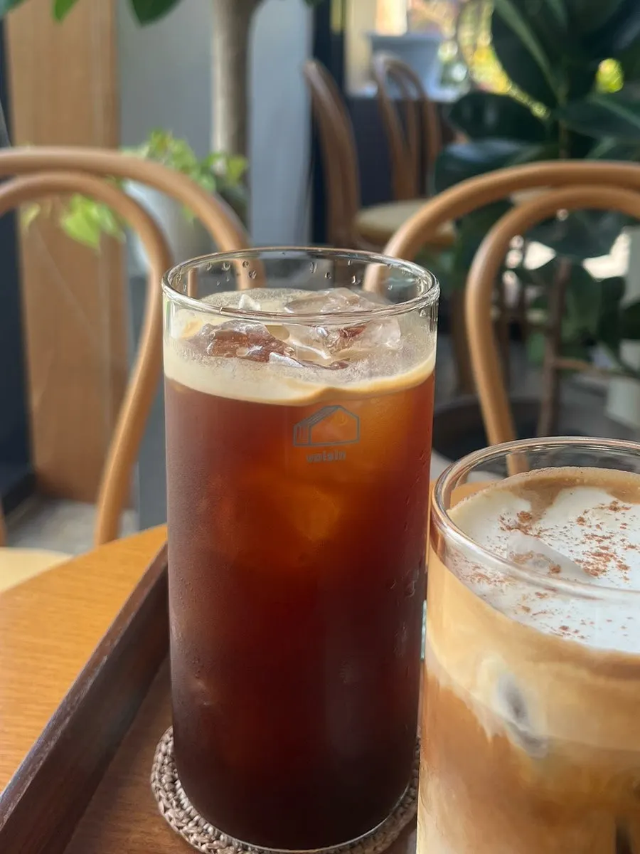 Stirring the maple cream latte with a straw