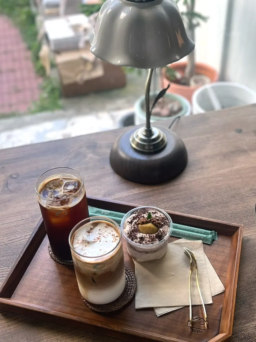 Coffee and dessert set against a green background