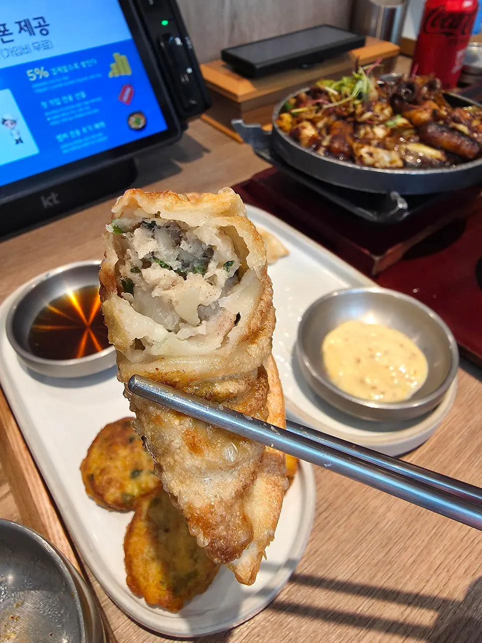 Fried mandu cut in half to show the filling