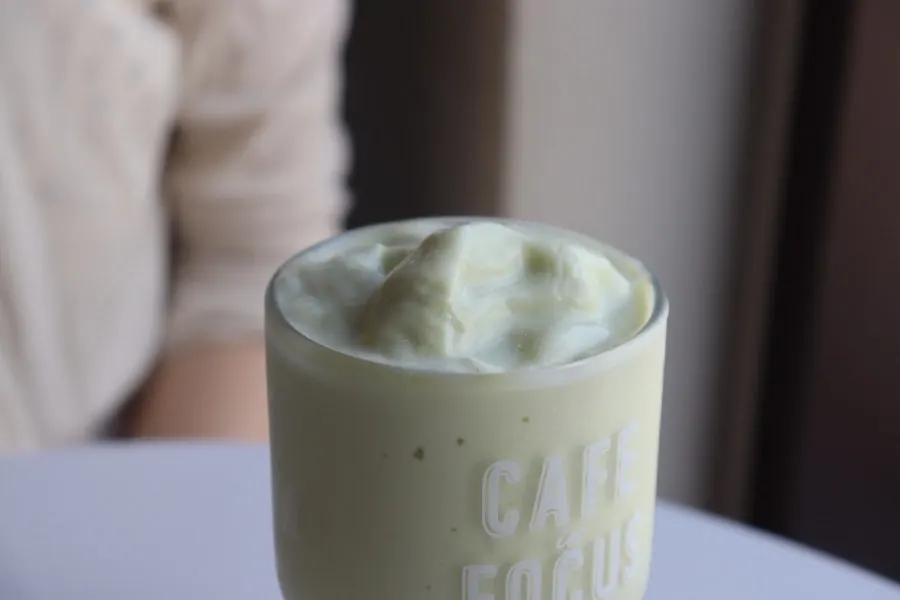 A glass of smooth, heavy-textured avocado smoothie