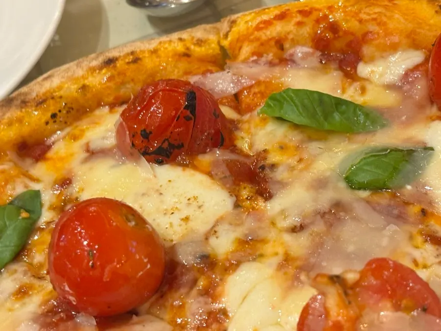 Margherita pizza topped with cherry tomatoes