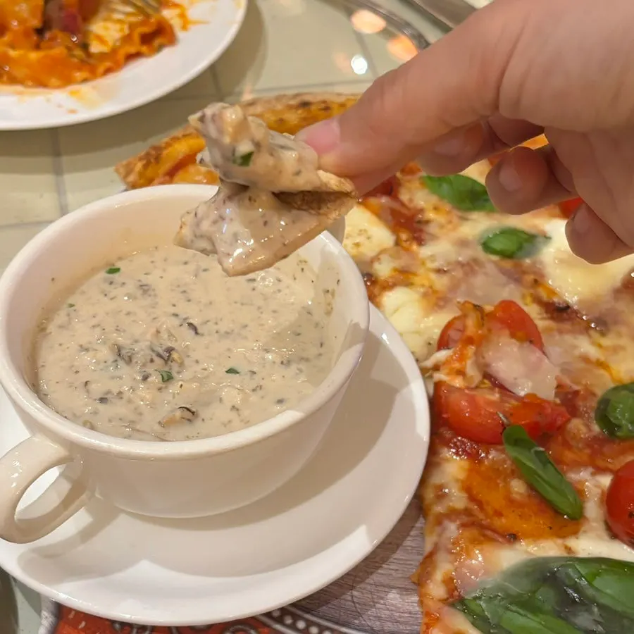 Dipping pizza crust into the truffle soup