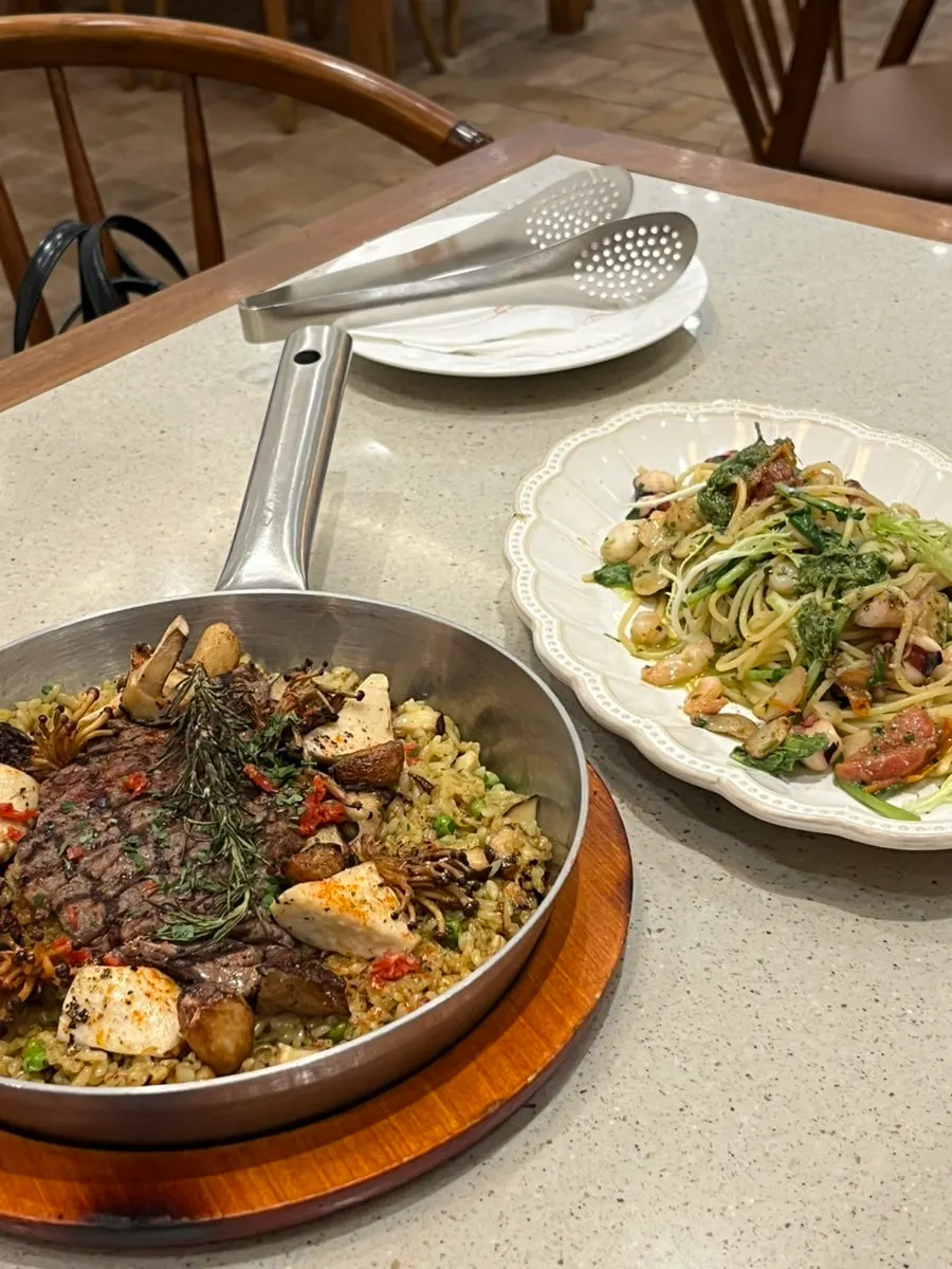 Table setting with hanwoo paella and octopus-shrimp pasta