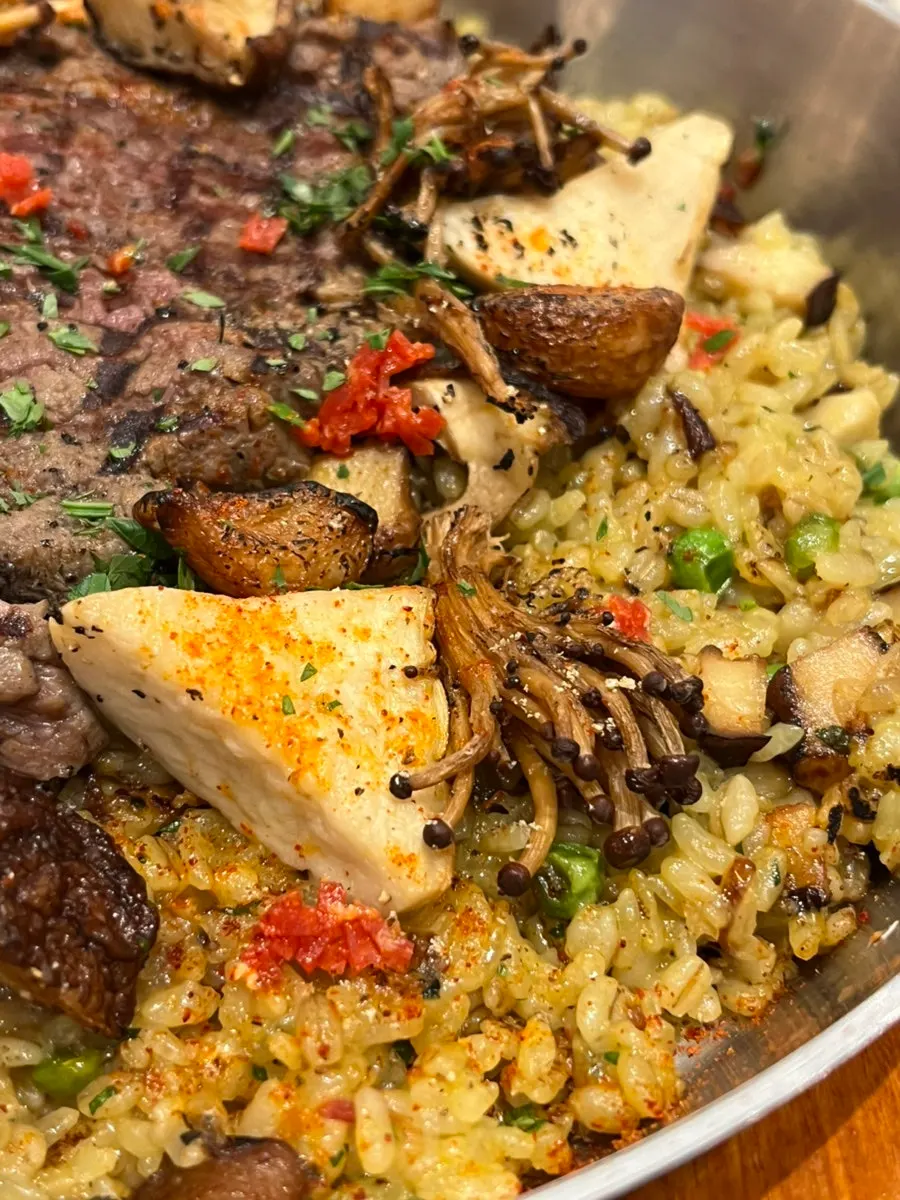 Close-up of grilled mushrooms on top of the paella