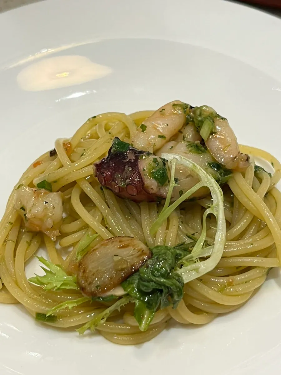 Close-up of an octopus piece in the pasta