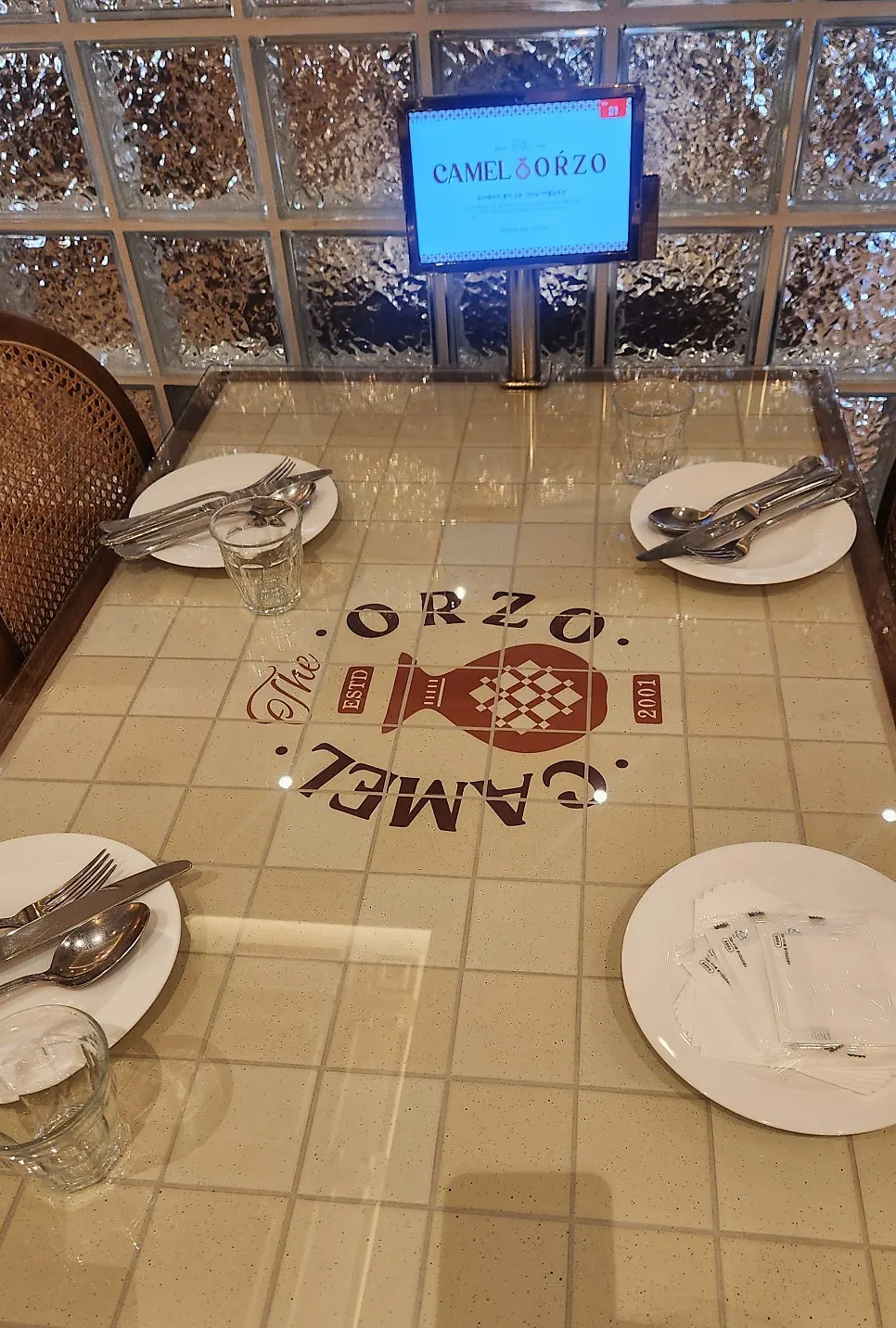 Clean table setting with an ordering tablet at each seat