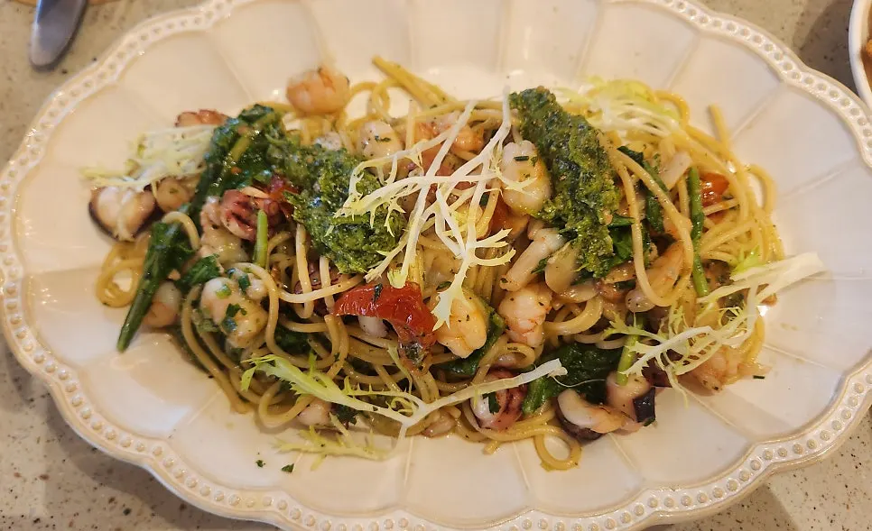 Red shrimp mare paella topped with shrimp, mussels, and octopus