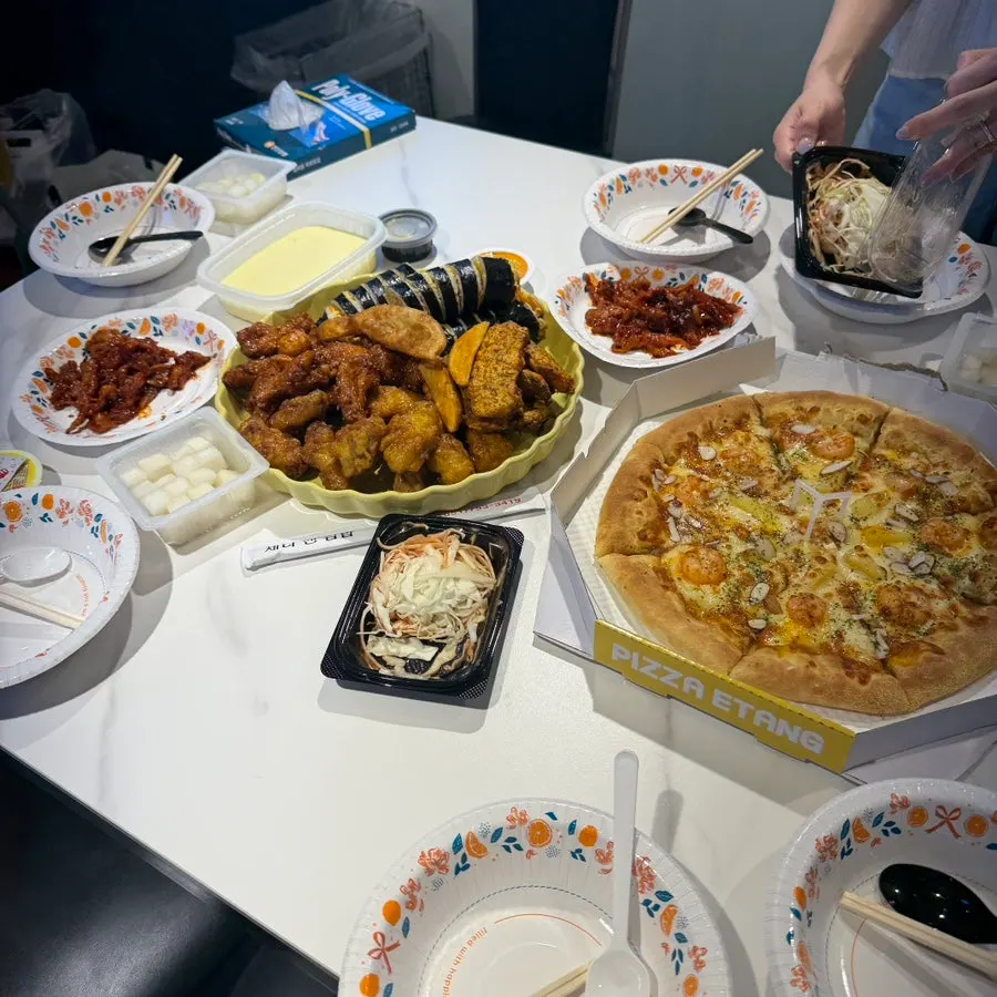 Party table set with food from a restaurant near Kyungsung University