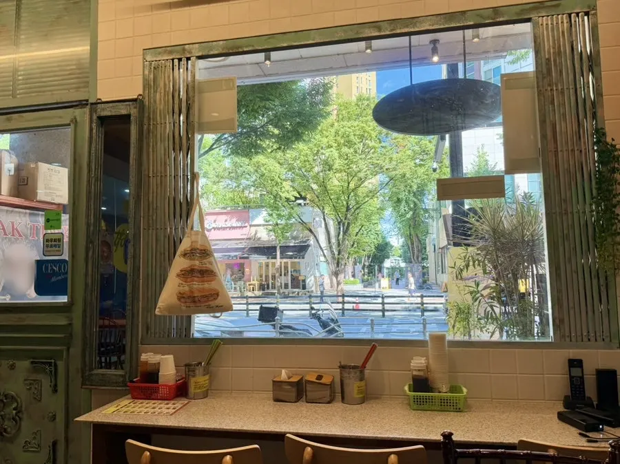 Window seat at Kkamon with green scenery outside