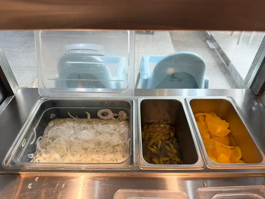 Self-serve bar with utensils and pickled side dishes at Kkamon