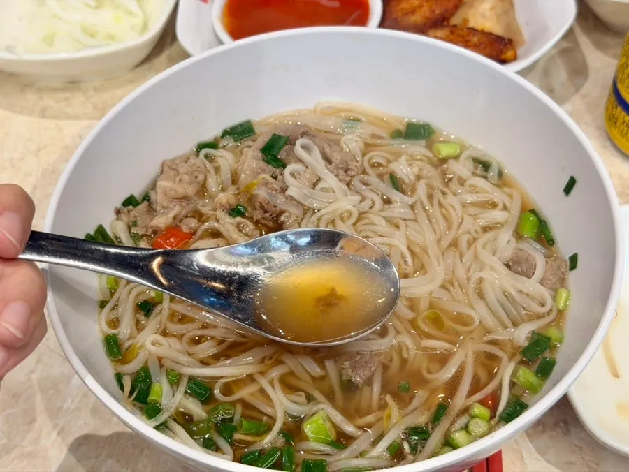 Close-up of Kkamon pho's clear broth