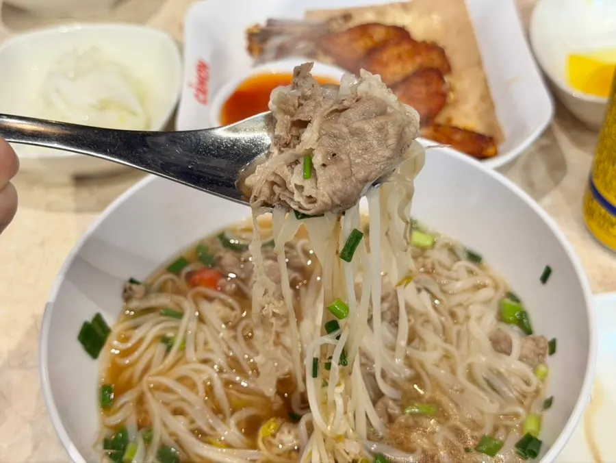 Lifting up a strand of pho noodles