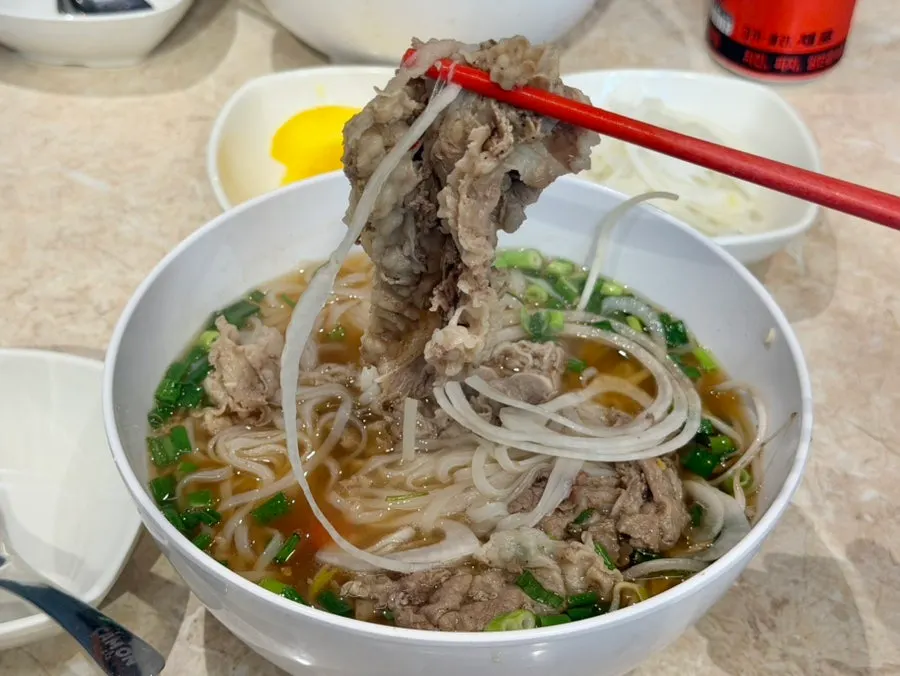 Pho meat dipped in hoisin and sriracha sauce
