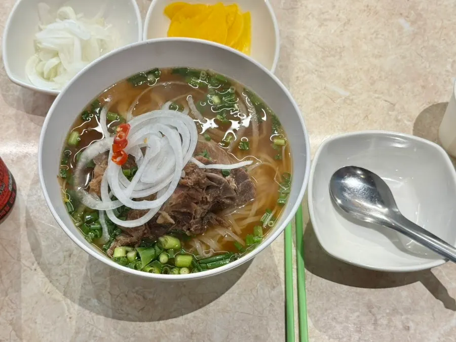 Kkamon pork backbone pho topped with pork backbone