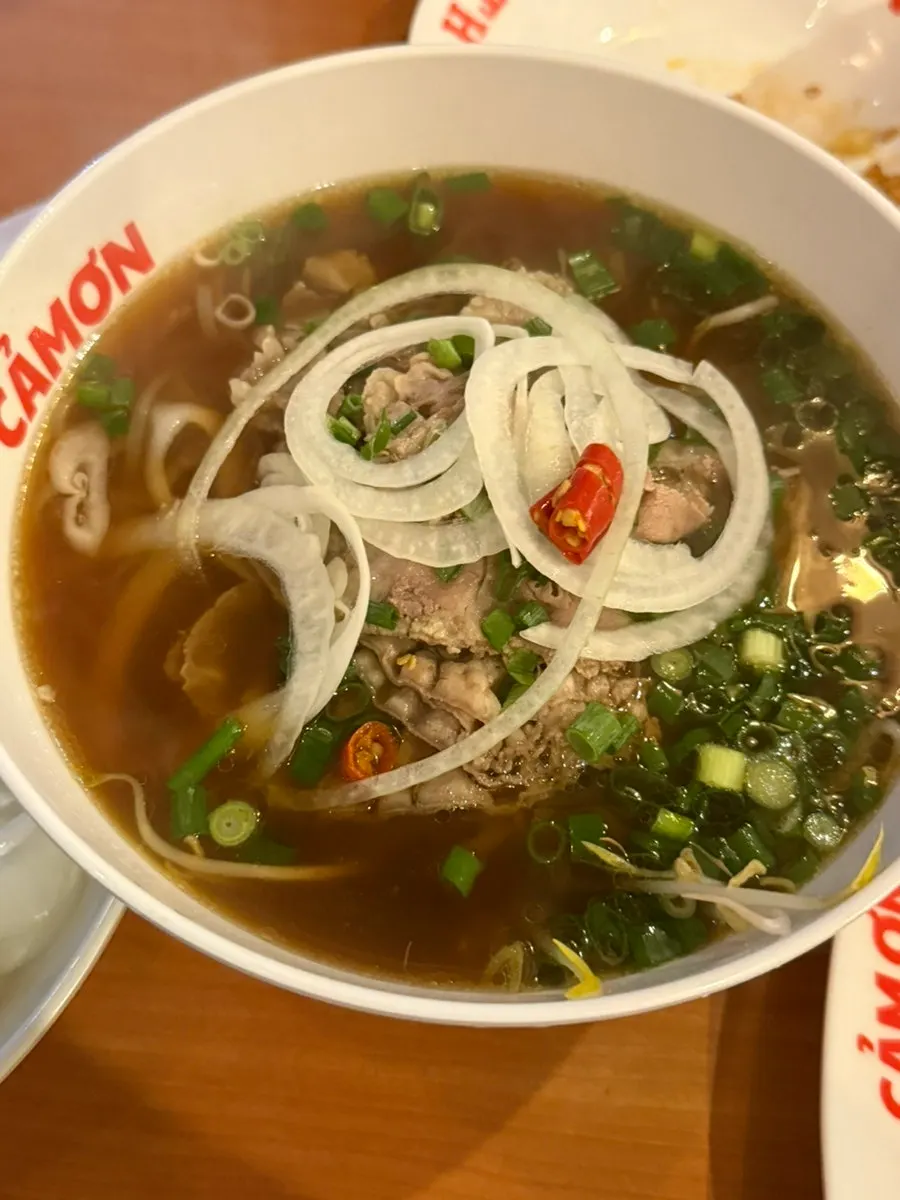 A bowl of Kkamon pho topped with brisket