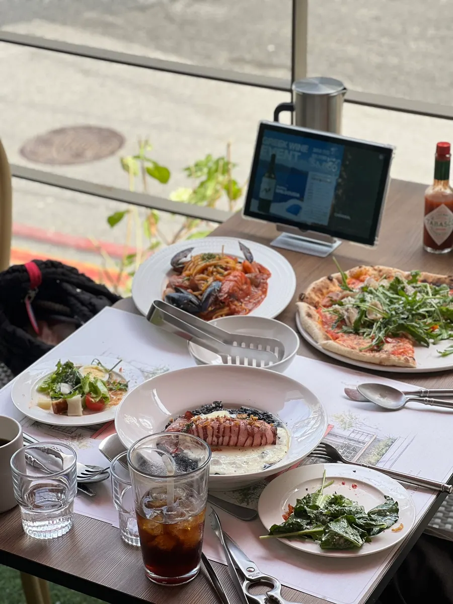 Table spread with pizza alongside the lunch set