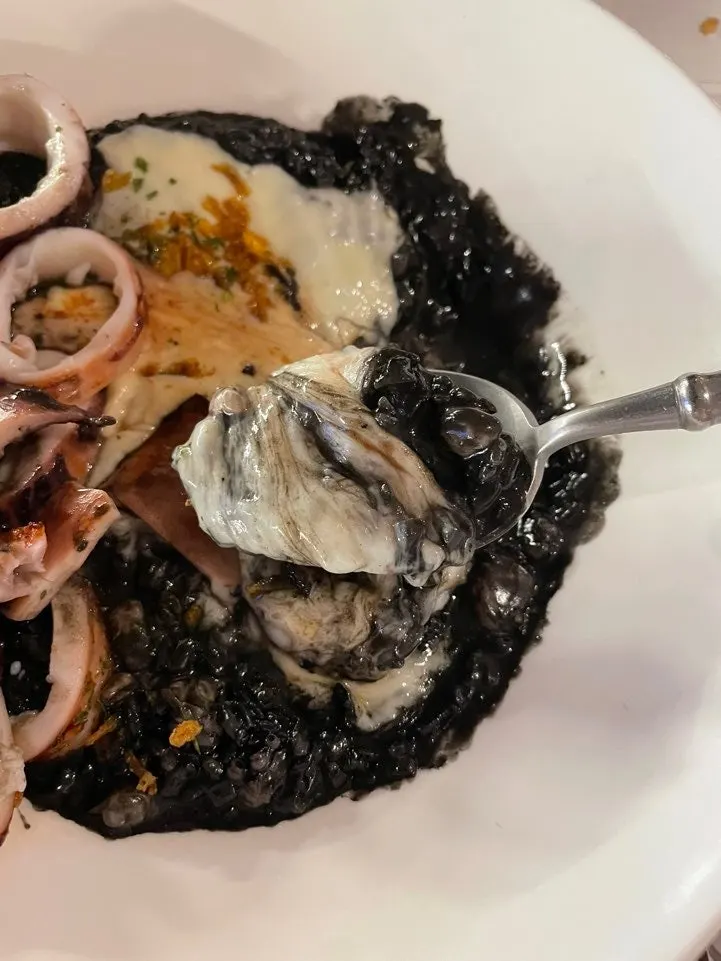 A forkful of the rich squid ink risotto
